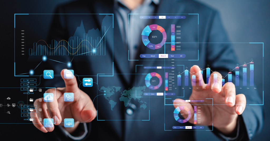 A professional man in a suit is interacting with a futuristic digital interface. The interface displays various graphs and analytical data, such as pie charts, bar graphs, and digital maps. The man is facing forward, gesturing with his hands to manipulate the virtual data screens that float in the air in front of him.